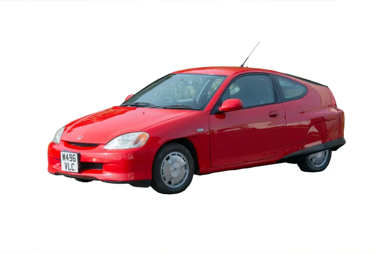 photograph of a small red Honda car.