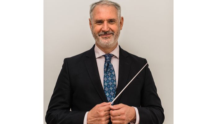 Conductor Paul MacAlindin poses with a baton