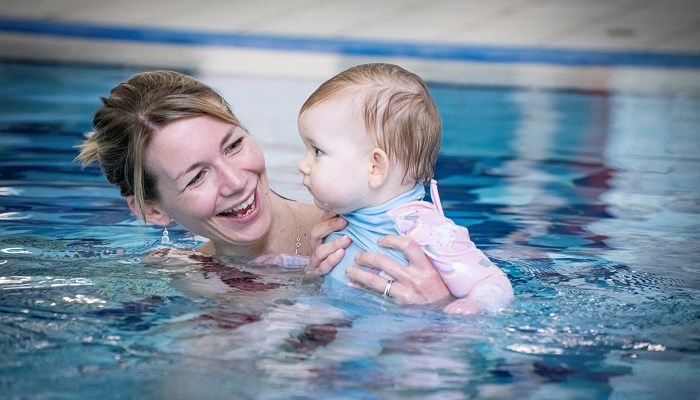A parent and child during a swimming lesson
