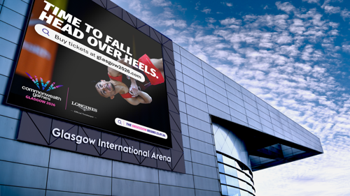 the exterior of Glasgow International Arena showing a large outdoor screen that has branding for gymnastics at Glasgow 2026 Commonwealth Games 
