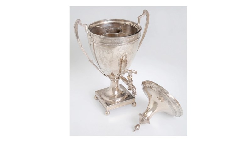 an image of a silver chalice with the lid sitting off to the right hand side.