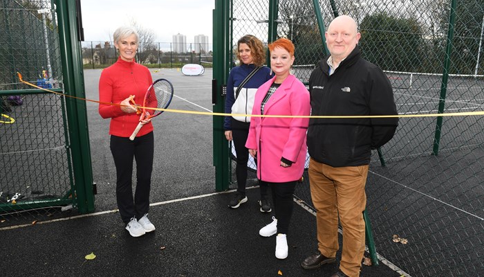 Four people standing in front of the entrance to the new Maryhill Park tennis courts