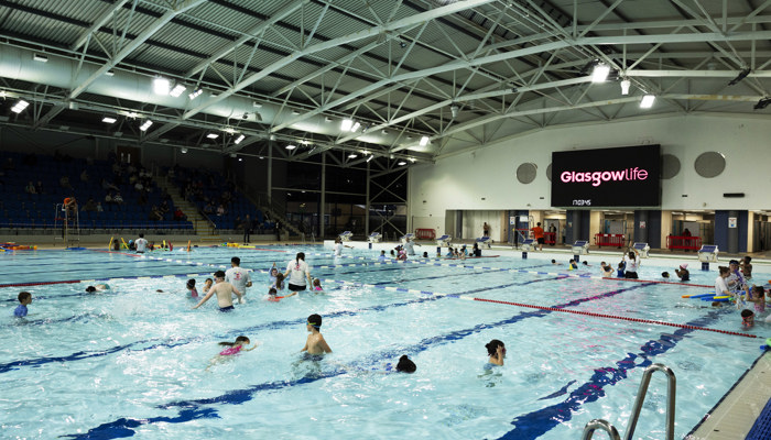 Youngsters take part in a Learn to Swim session with instructors in a Glasgow Life pool.