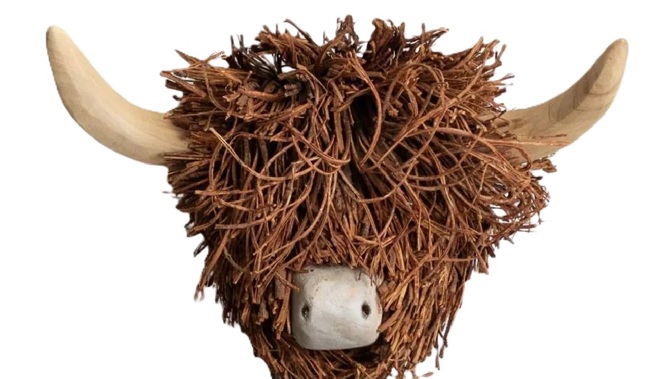 Handcrafted Highland cow head decoration with shaggy brown fibres and wooden horns.