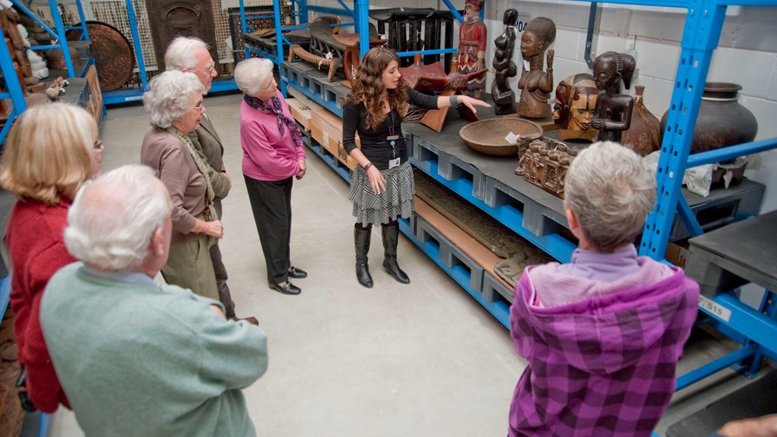 Photograph showing a tour in progress at Glasgow Museums Resource Centre.