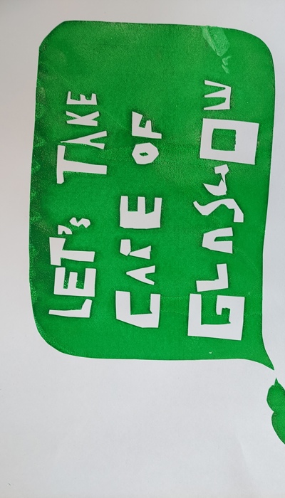 Screen printed in green the artwork reads "lets take care of Glasgow"