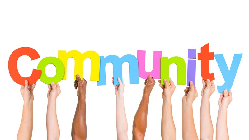 Arms holding up individual letters to spell out the word 'Community'