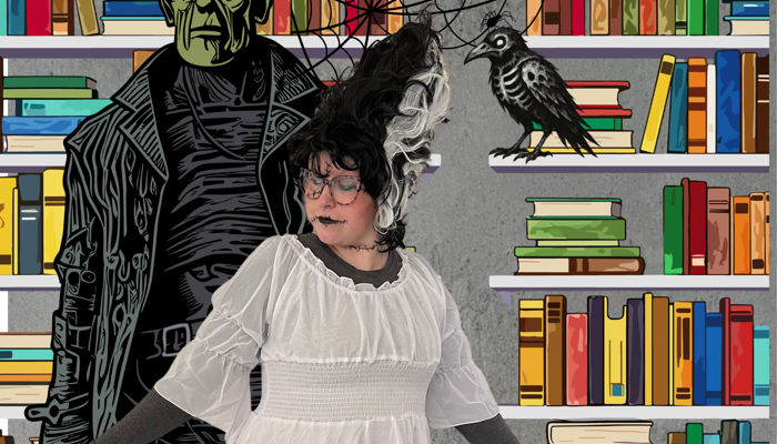 A person dressed in white dress poses as the bride of Frankenstein in a library in front of an illustration of Frankenstein's monster