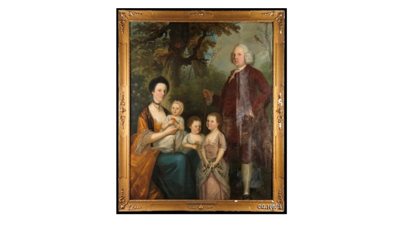 painted family portrait showing 5 people in a wooded setting inset within a golden frame.