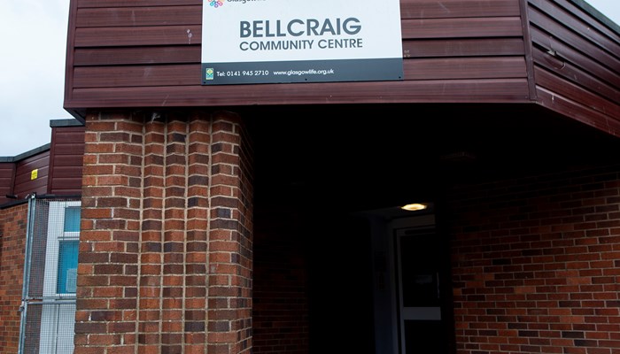 brown brick building with a sign saying bellcraig community centre above the door