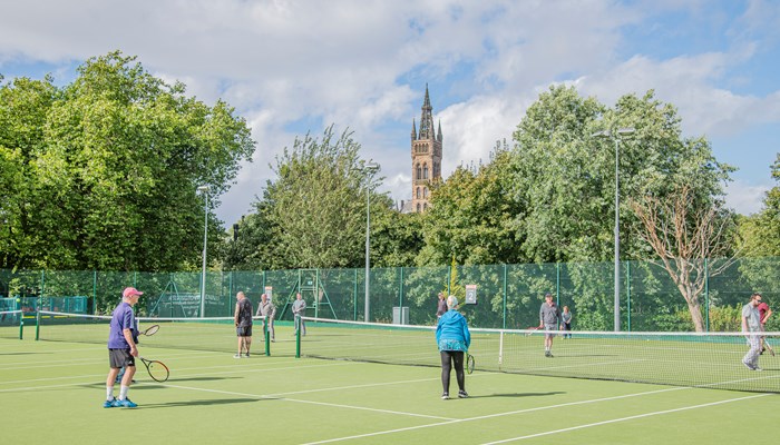 Group of people playing tennis at Kelvingrove Tennis courts. 