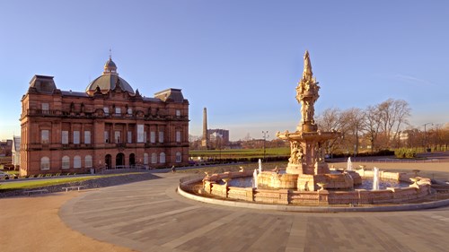 People's Palace and fountain pictured with Glasgow Green in the background. It is sunny