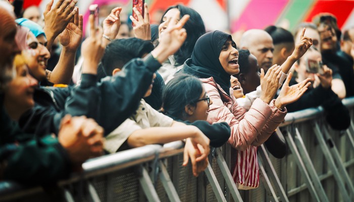 A crowd watches on as musicians perform at a South Asian festival of music, dance and arts