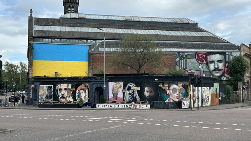 Exterior of The Clutha featuring a range of illustrated portraits in different art styles