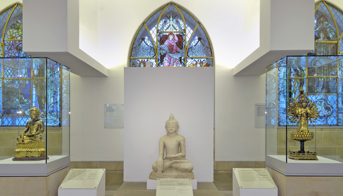 Photograph showing a view inside the Religious Art space, showing a selection of Religious objects and displays on the first floor of St Mungo.