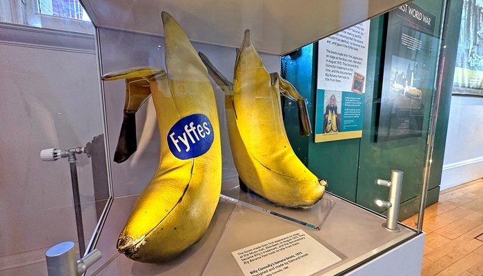 Photograph showing the comedian Billy Connolly's 'Banana Boots' which he used to wear on stage, and donated to the People's Palace.