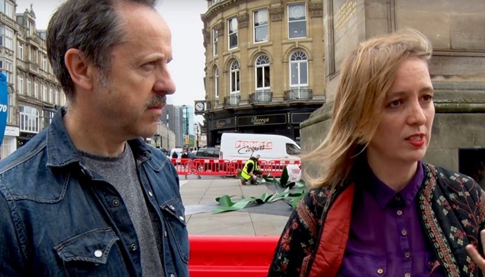 Artists Neil Bromwich and Zoe Walker pictured on a city street