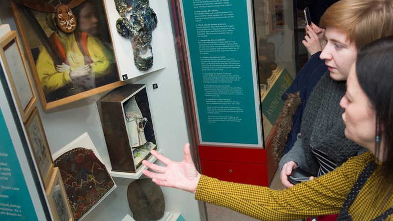 Photograph showing two people learning about a display from The Open Museum.