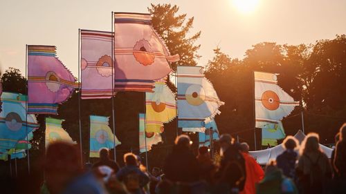 Crowds at a music festival in the sunshine