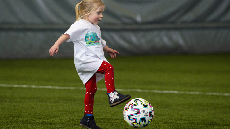 A child controlling a football