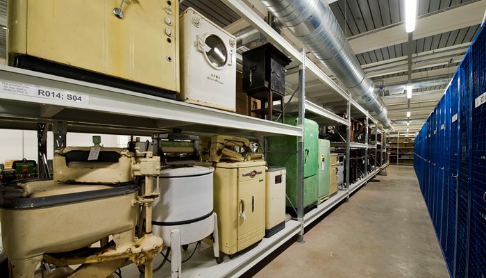 Photograph shows a collection of vintage washing machines and fridges stored at GMRC.